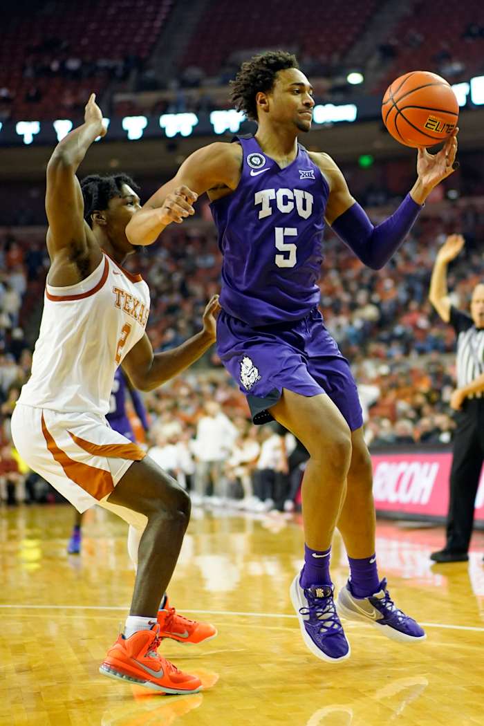 Feb 23, 2022; Austin, Texas, USA; Texas Christian Horned Frogs forward Chuck O'Bannon Jr. (5) tries to control the ball while defended by Texas Longhorns guard Marcus Carr (2) during the second half at Frank C. Erwin Jr. Center. Mandatory Credit: Scott Wachter-USA TODAY Sports
